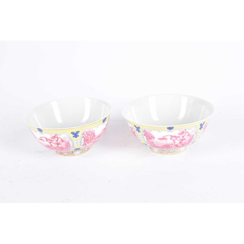 277 - A pair of Chinese famille rose bowls, the interiors painted with a sprig of peony, the exterior with... 