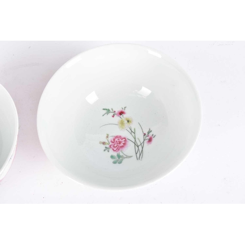 277 - A pair of Chinese famille rose bowls, the interiors painted with a sprig of peony, the exterior with... 