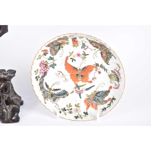 279 - A Chinese porcelain fluted saucer, Qing, painted with butterflies and floral sprigs, the underside w... 