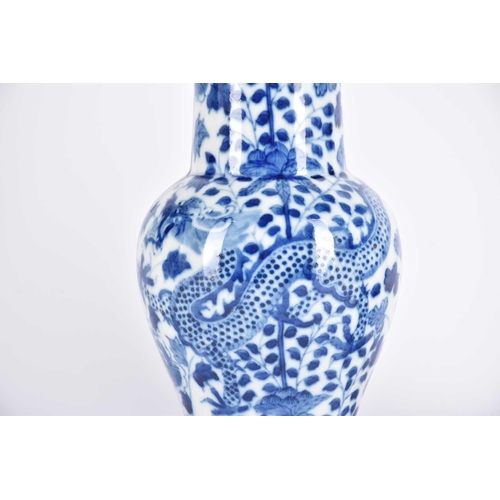 290 - A pair of Chinese blue & white fengweizun vases, painted with opposing dragons amongst lotus and tre... 