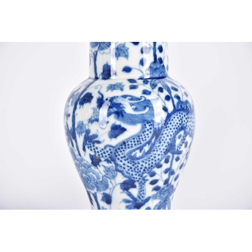 290 - A pair of Chinese blue & white fengweizun vases, painted with opposing dragons amongst lotus and tre... 