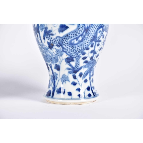 290 - A pair of Chinese blue & white fengweizun vases, painted with opposing dragons amongst lotus and tre... 