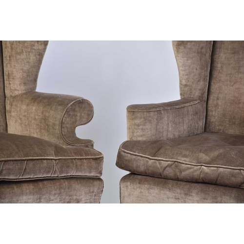 303 - Two similar George II style wing back fireside armchairs, early 20th century, with mushroom coloured... 