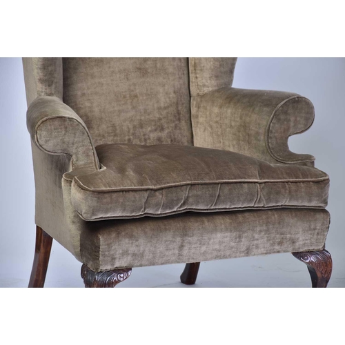 303 - Two similar George II style wing back fireside armchairs, early 20th century, with mushroom coloured... 