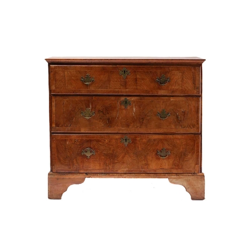 304 - A Queen Anne walnut and oak chest of four long drawers With broad crossbanded top above drawer front... 