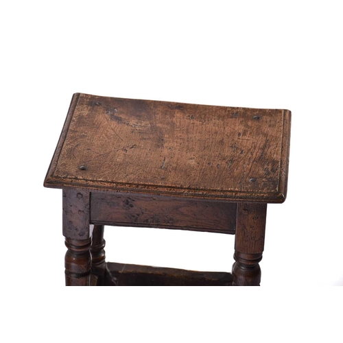 306 - A Jacobean style oak joint stool with thumb moulded top over carved, slender cup and cover spindles ... 