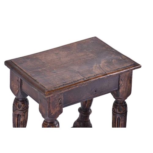 306 - A Jacobean style oak joint stool with thumb moulded top over carved, slender cup and cover spindles ... 