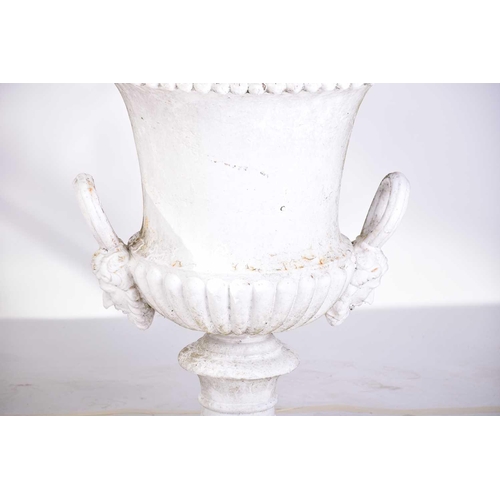 310 - A pair of cast iron two-handled campana urns with gadrooned rims. on composite square socle bases. 5... 