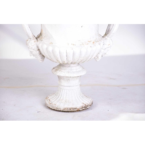 310 - A pair of cast iron two-handled campana urns with gadrooned rims. on composite square socle bases. 5... 