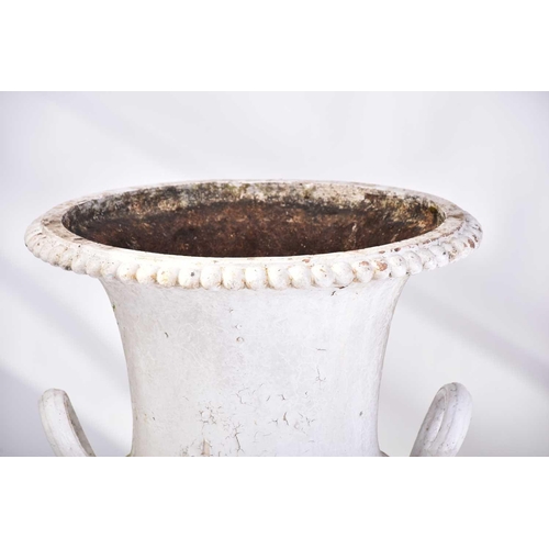 310 - A pair of cast iron two-handled campana urns with gadrooned rims. on composite square socle bases. 5... 