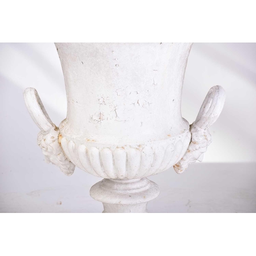 310 - A pair of cast iron two-handled campana urns with gadrooned rims. on composite square socle bases. 5... 