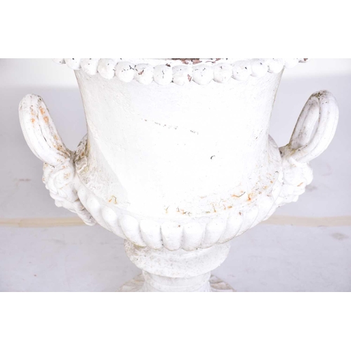 310 - A pair of cast iron two-handled campana urns with gadrooned rims. on composite square socle bases. 5... 