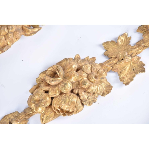 318 - A pair of 19th century carved wood and gilt gesso wall appliques in the form of hanging harvest boun... 