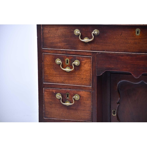 322 - A George III mahogany kneehole writing desk the frieze drawer with fitted interior and baize lined s... 