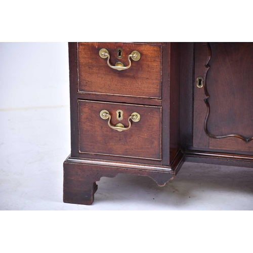 322 - A George III mahogany kneehole writing desk the frieze drawer with fitted interior and baize lined s... 