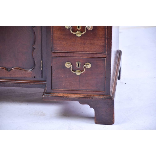 322 - A George III mahogany kneehole writing desk the frieze drawer with fitted interior and baize lined s... 