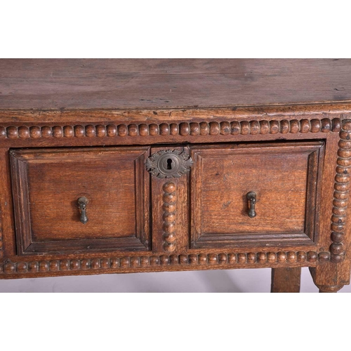 327 - A late 17th-century oak two drawer side table each drawer with geometric moulding and split bobbin d... 