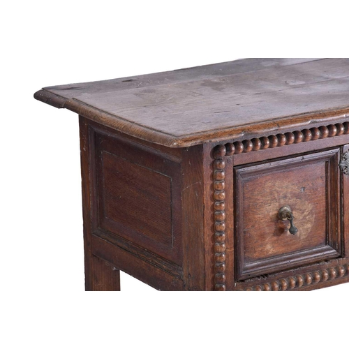 327 - A late 17th-century oak two drawer side table each drawer with geometric moulding and split bobbin d... 