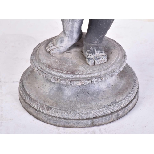 328 - A Victorian-style cast lead garden figure of a child on a circular moulded socle base. 67 cm overall... 