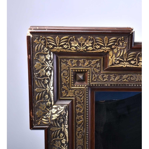 332 - A large late Victorian carved wood and moulded shellac wall mirror of rectangular re-entrant form wi... 