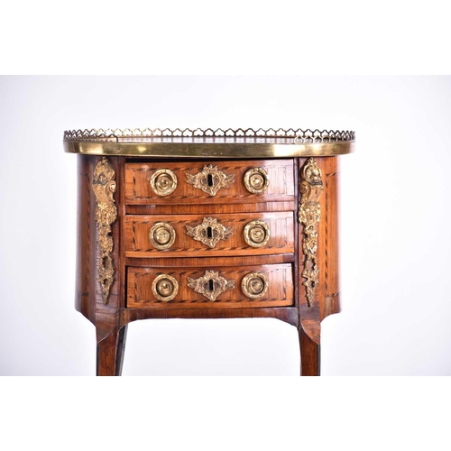 339 - A Louis XVI satinwood and tulipwood Table en Chiffonier of oval section with pierced gallery top abo... 