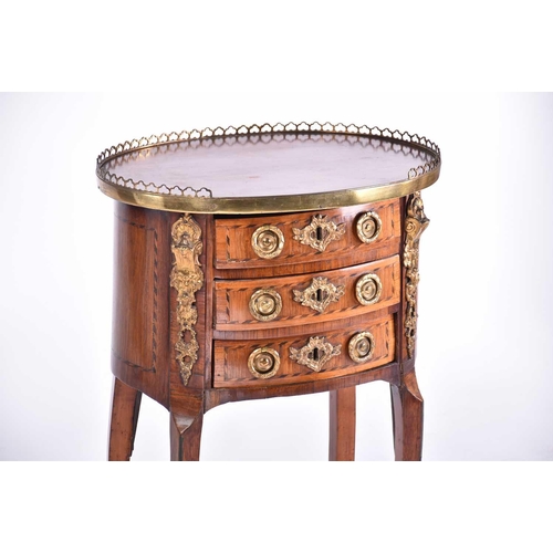 339 - A Louis XVI satinwood and tulipwood Table en Chiffonier of oval section with pierced gallery top abo... 