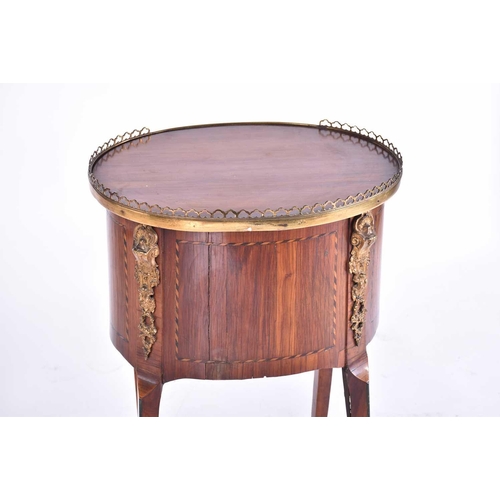 339 - A Louis XVI satinwood and tulipwood Table en Chiffonier of oval section with pierced gallery top abo... 