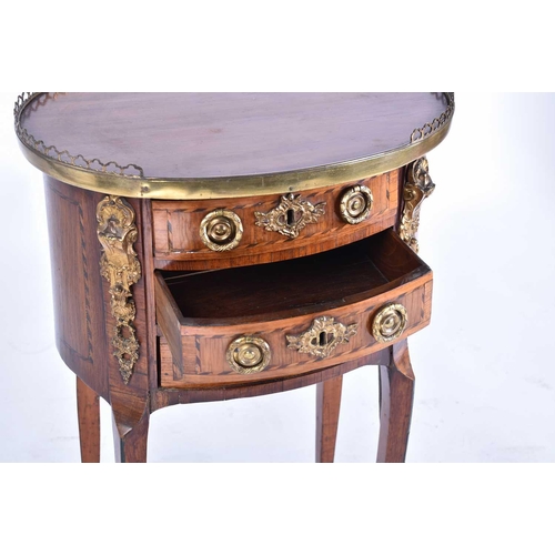 339 - A Louis XVI satinwood and tulipwood Table en Chiffonier of oval section with pierced gallery top abo... 