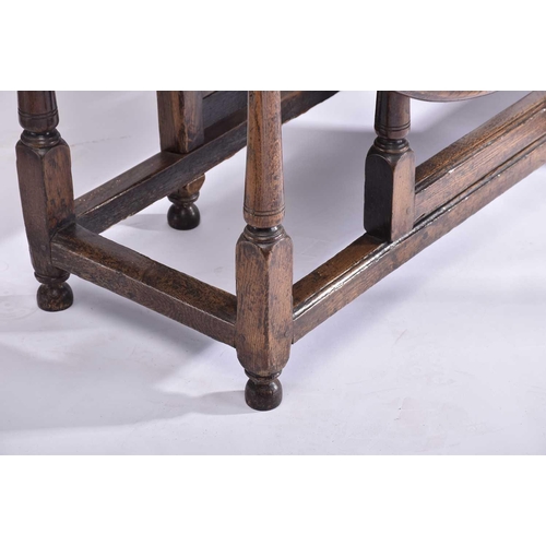 344 - An early 18th-century oak oval gateleg table with single frieze drawer and turned Doric column spind... 