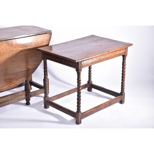 344 - An early 18th-century oak oval gateleg table with single frieze drawer and turned Doric column spind... 