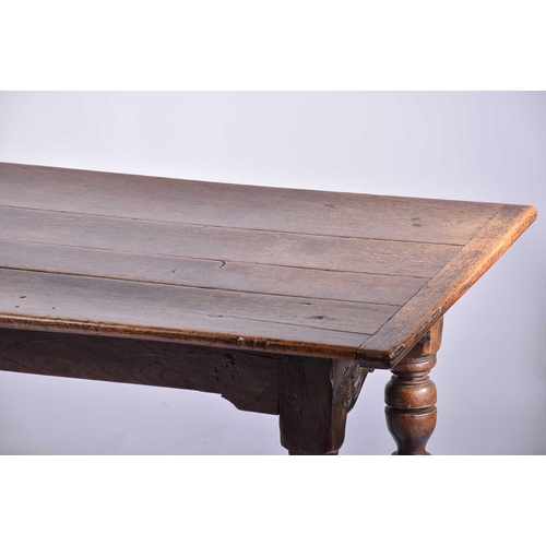 349 - A 17th century oak refectory table with clamped plank top on a box frame base with slender cup and c... 