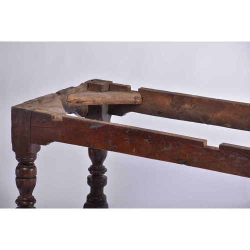 349 - A 17th century oak refectory table with clamped plank top on a box frame base with slender cup and c... 