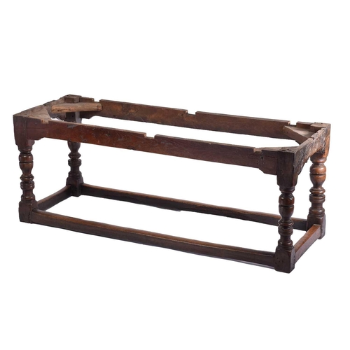 349 - A 17th century oak refectory table with clamped plank top on a box frame base with slender cup and c... 