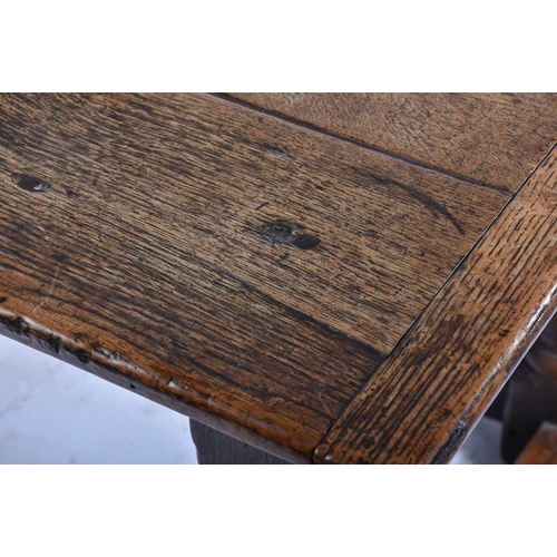 349 - A 17th century oak refectory table with clamped plank top on a box frame base with slender cup and c... 