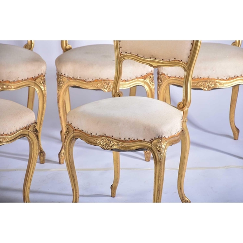 355 - † A set of six Louis XV style carved wood and gilt gesso salon chairs, early 20th century, with flor... 