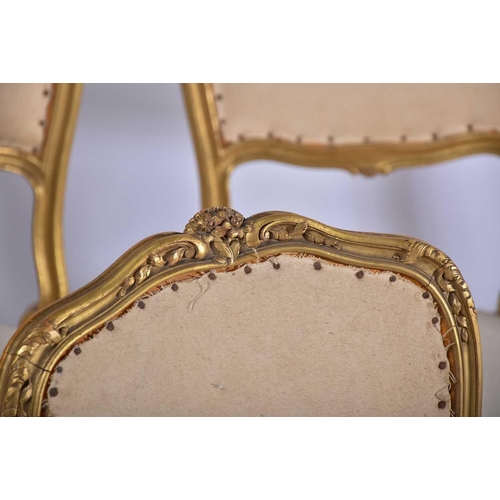 355 - † A set of six Louis XV style carved wood and gilt gesso salon chairs, early 20th century, with flor... 