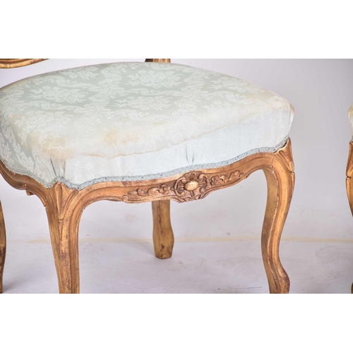 356 - A pair of Louis XV style carved wood and gilt gesso side chairs, 20th century. with cartouch carved ... 