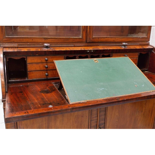 358 - A George IV mahogany cylinder bureau bookcase. the upper section with a pair of plain glazed doors a... 