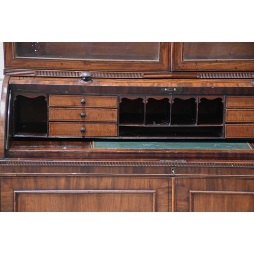 358 - A George IV mahogany cylinder bureau bookcase. the upper section with a pair of plain glazed doors a... 