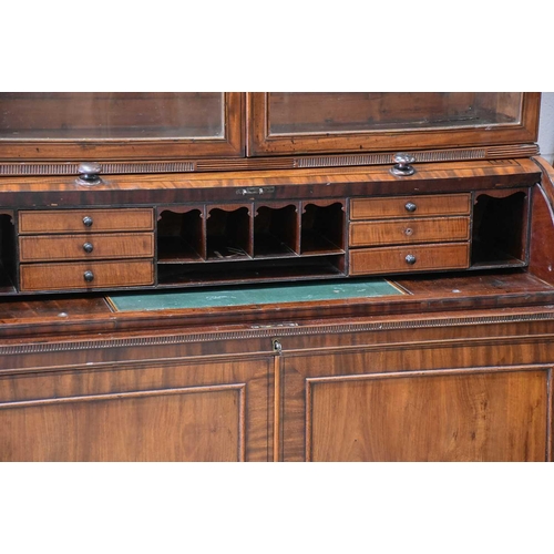 358 - A George IV mahogany cylinder bureau bookcase. the upper section with a pair of plain glazed doors a... 