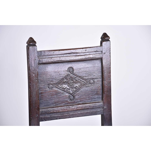 362 - A 17th-century style oak back stool with carved decoration and a solid seat above a shaped frieze. S... 