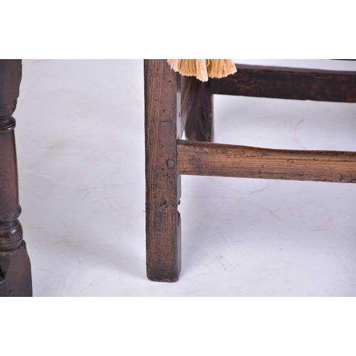 362 - A 17th-century style oak back stool with carved decoration and a solid seat above a shaped frieze. S... 