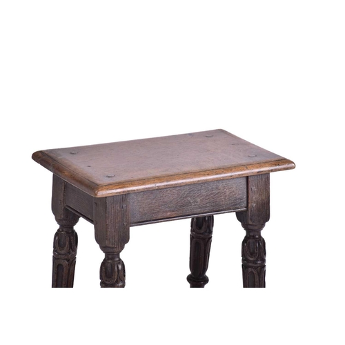 371 - A Jacobean style oak joint stool with thumb moulded top over carved, slender cup and cover spindles ... 