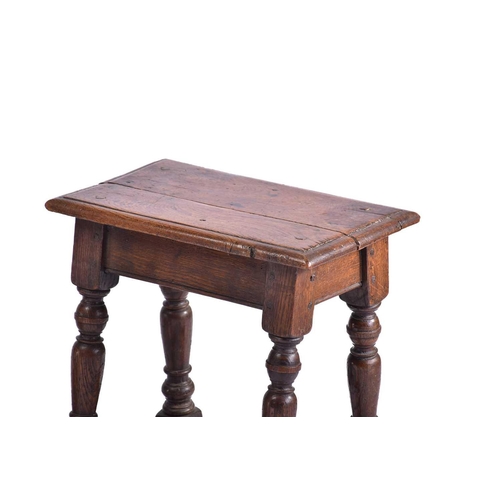 371 - A Jacobean style oak joint stool with thumb moulded top over carved, slender cup and cover spindles ... 