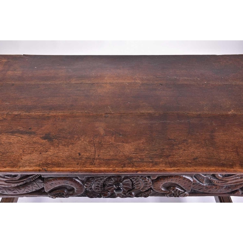 373 - A 17th-century style oak single drawer side table with a planked top and carved frieze, on turned cu... 