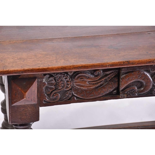 373 - A 17th-century style oak single drawer side table with a planked top and carved frieze, on turned cu... 