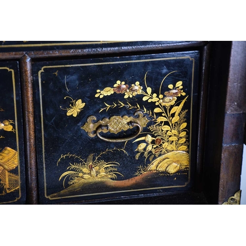 375 - A Queen Anne black lacquer double dome cabinet on a gilt stand. The upper section is decorated throu... 