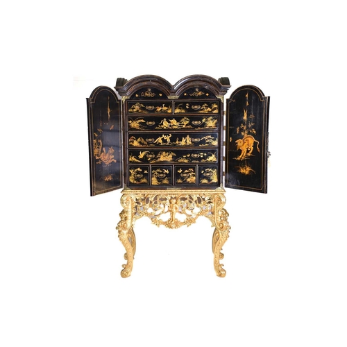 375 - A Queen Anne black lacquer double dome cabinet on a gilt stand. The upper section is decorated throu... 