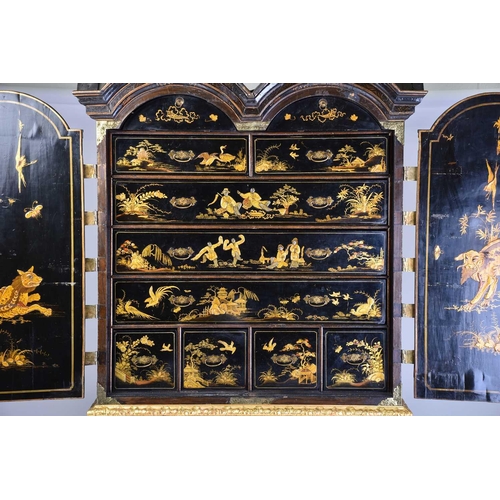 375 - A Queen Anne black lacquer double dome cabinet on a gilt stand. The upper section is decorated throu... 