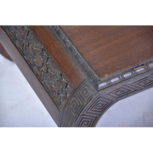 383 - A Chinese Kang style camphor wood low table, 20th century, carved with peony and Greek key bands, 11... 